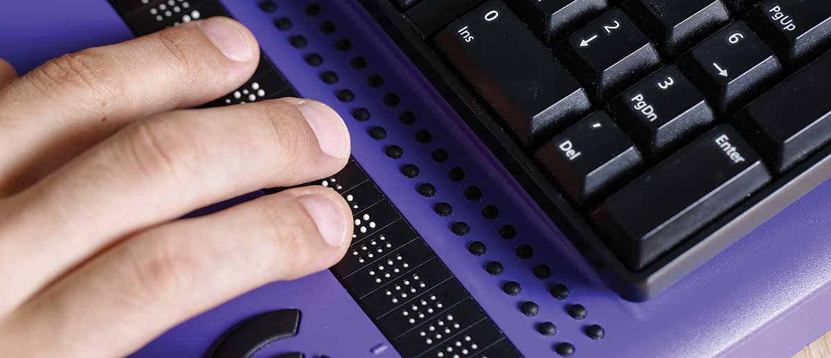 hands operating a Braille keyboard